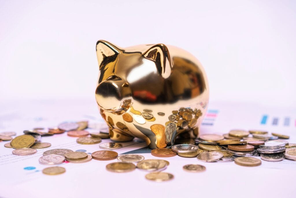 gold piggy bank surrounded by coins for TFSA and RRSP post