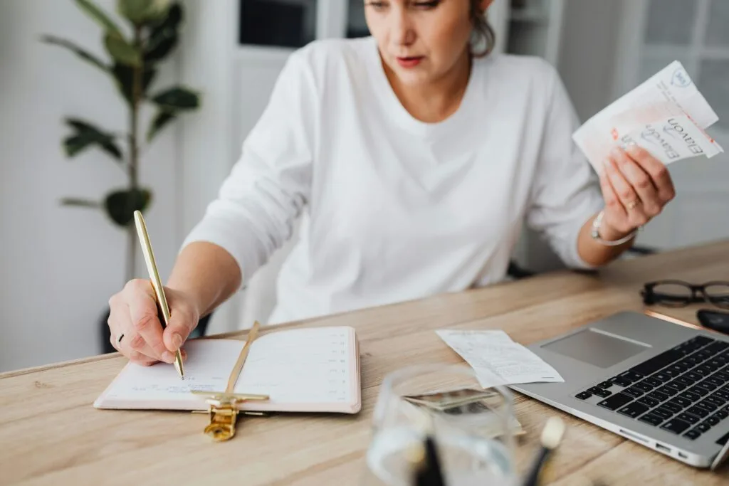 Woman learning and starting to budget to help reduce her financial shame.