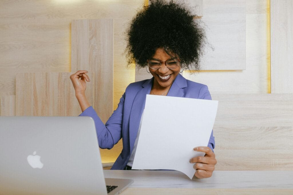 Woman celebrating succeeding at her savings goal
